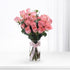 Soft pink roses in clear vase, tied with branded pink ribbon.
