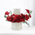 Luxurious red roses and carnations in elegant white box with gold-embossed card.