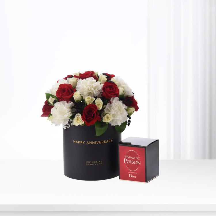 Elegant red and white roses in black "Happy Anniversary" box, paired with Dior Hypnotic Poison perfume.