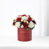 Red velvet box holds vibrant red roses and white carnations, elegant gift for love.