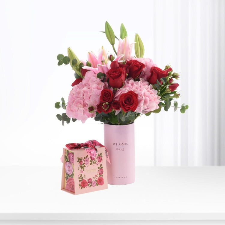 Pink vase with red roses, hydrangeas, and lilies; "It&