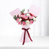 Pink-wrapped bouquet with red, pink, and white roses, accented by greenery and a burgundy ribbon.