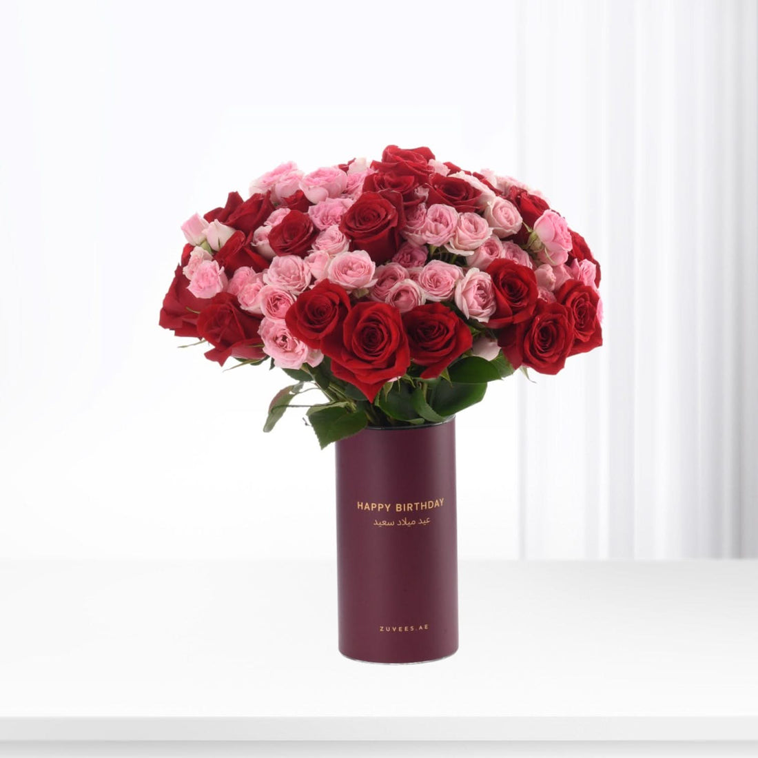 Luxurious red and pink roses in burgundy "Happy Birthday" vase, elegant gift for celebrations.