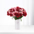 Vibrant red and pink roses in minimalist white vase with bilingual apology message.