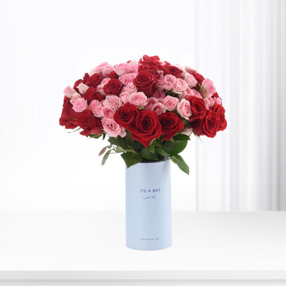 Vibrant red and pink roses in light blue "It&