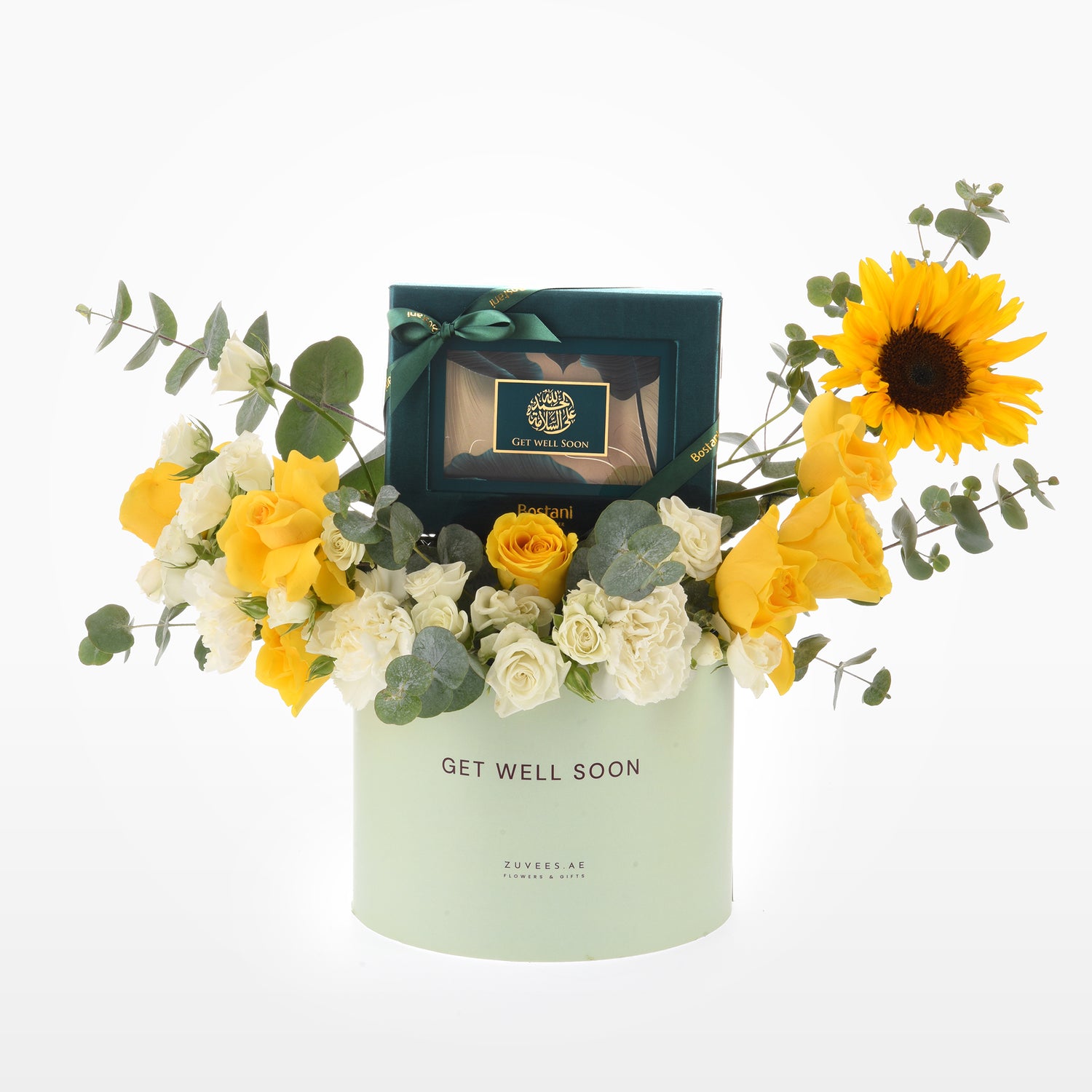 Pastel green box holds vibrant yellow roses, sunflower, and eucalyptus with "Get Well Soon" gift inside.