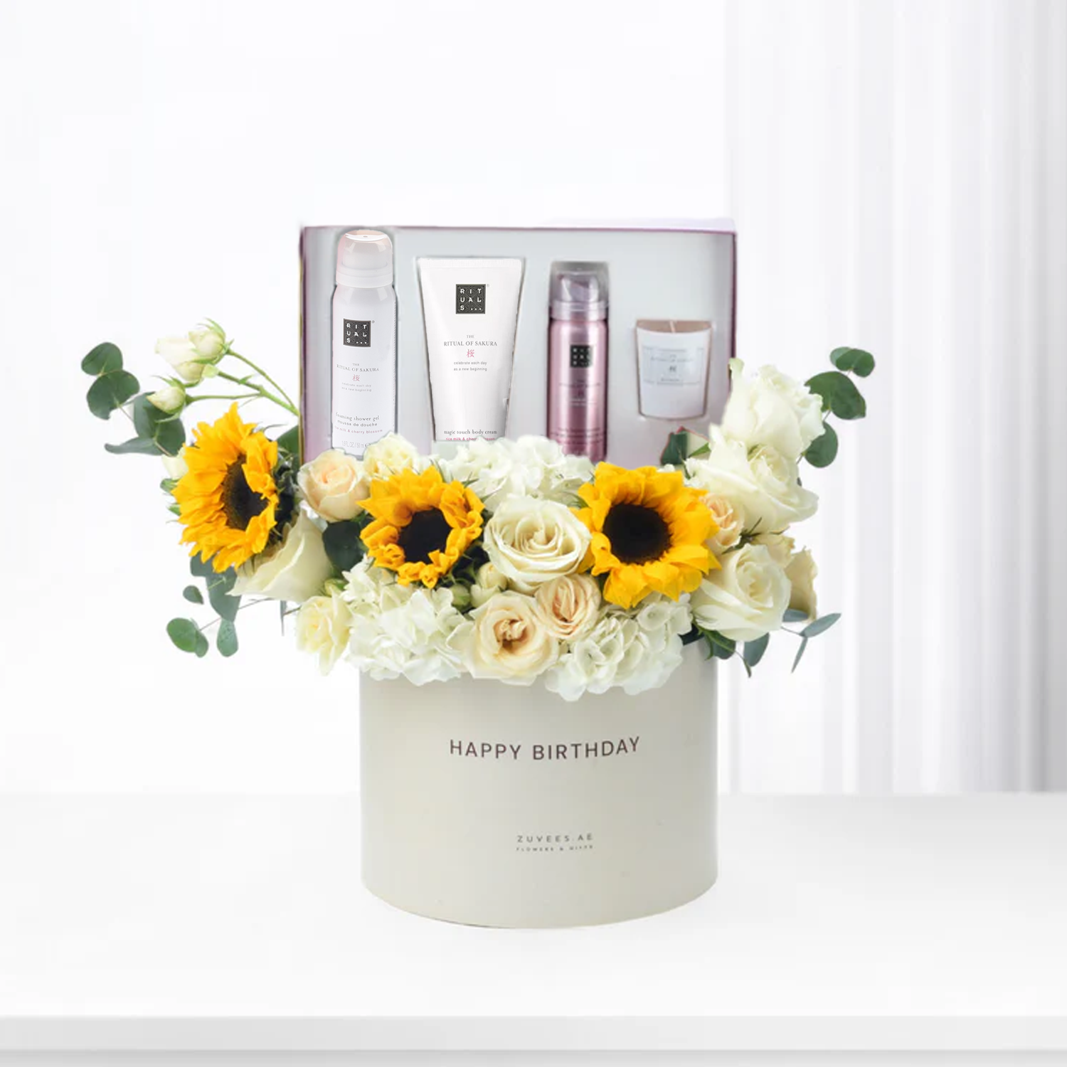 White box holds sunflowers, roses, and Rituals spa set for birthday.