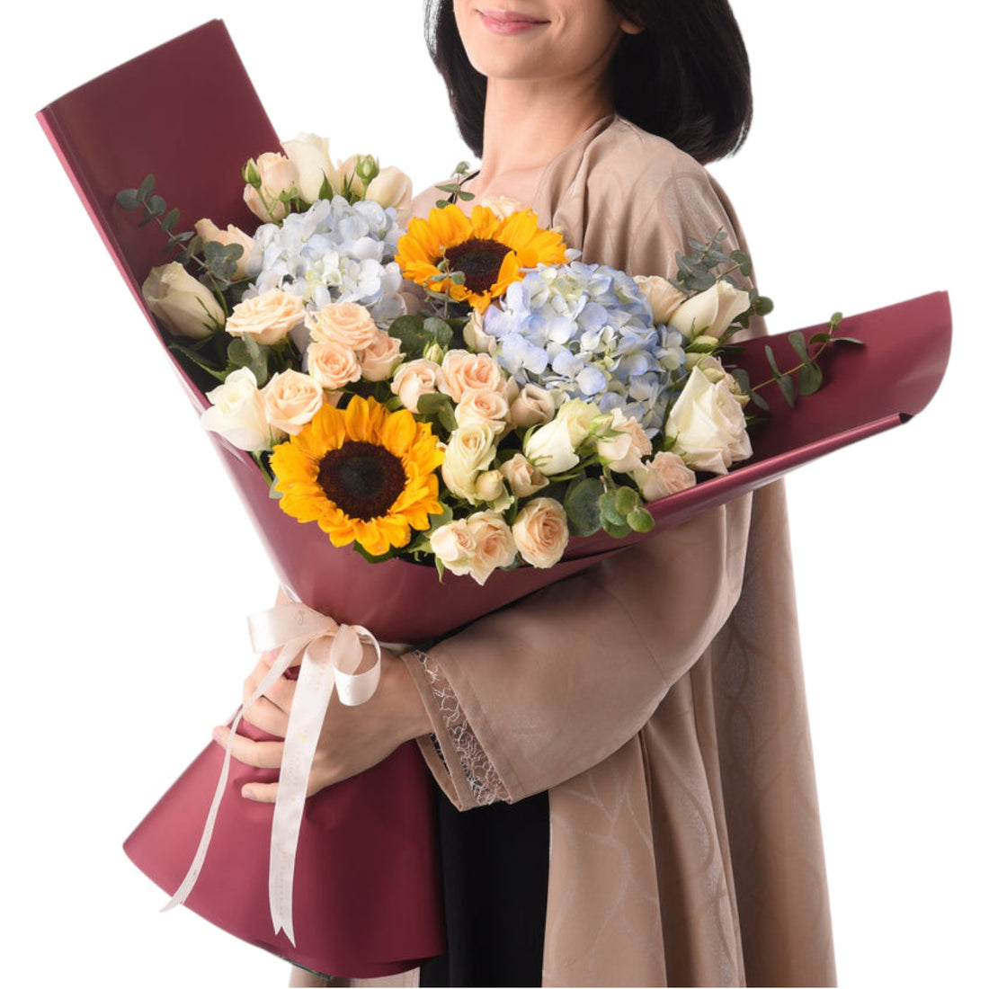 Vibrant sunflowers, roses, and hydrangeas in burgundy wrap with cream ribbon.