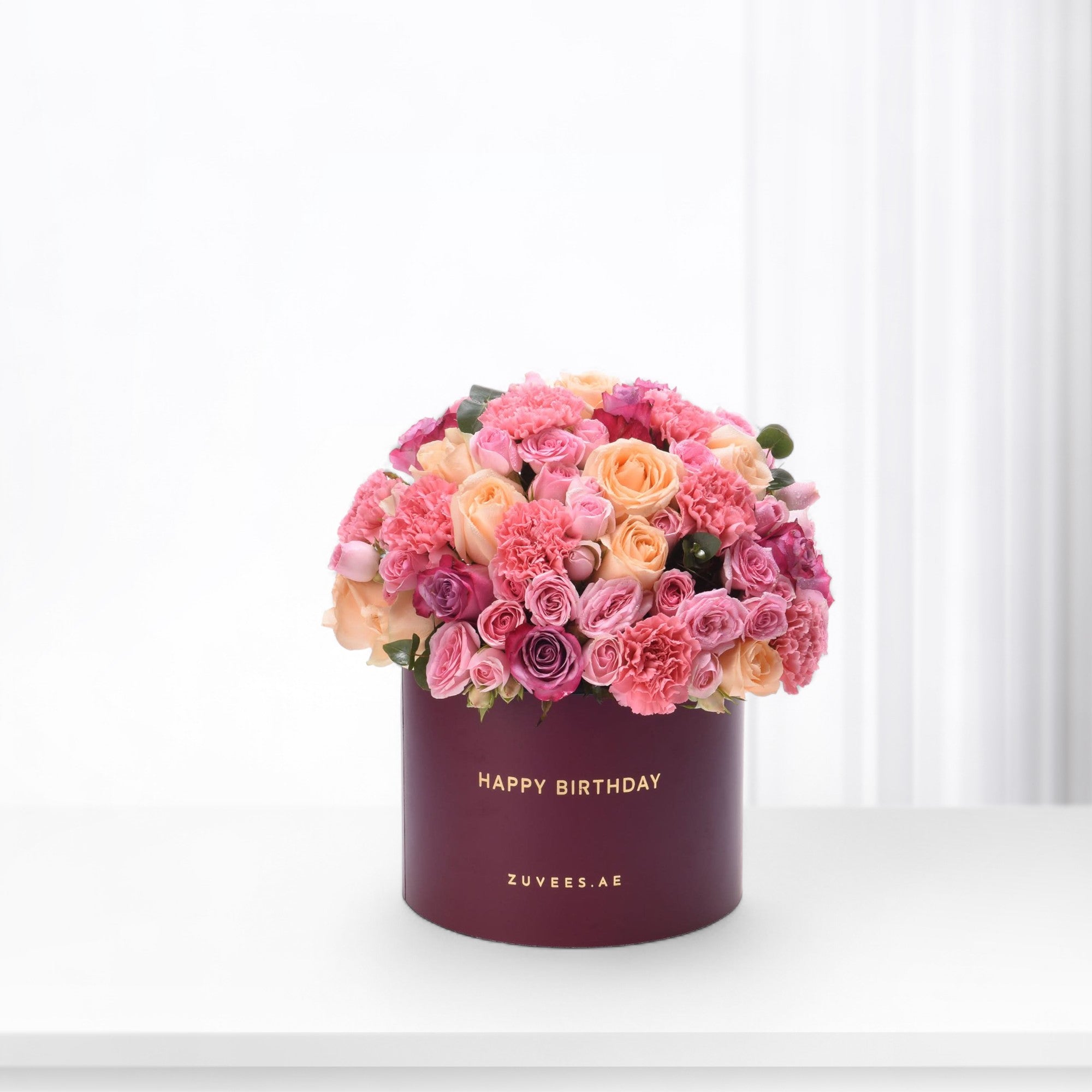 Vibrant pink and peach roses &amp; carnations in burgundy box with "Happy Birthday" gold text.