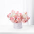 Soft pink roses and hydrangeas bloom elegantly in a branded white box.