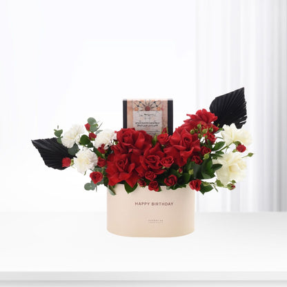 Elegant red and white roses in beige box with "Happy Birthday" and chocolate gift.