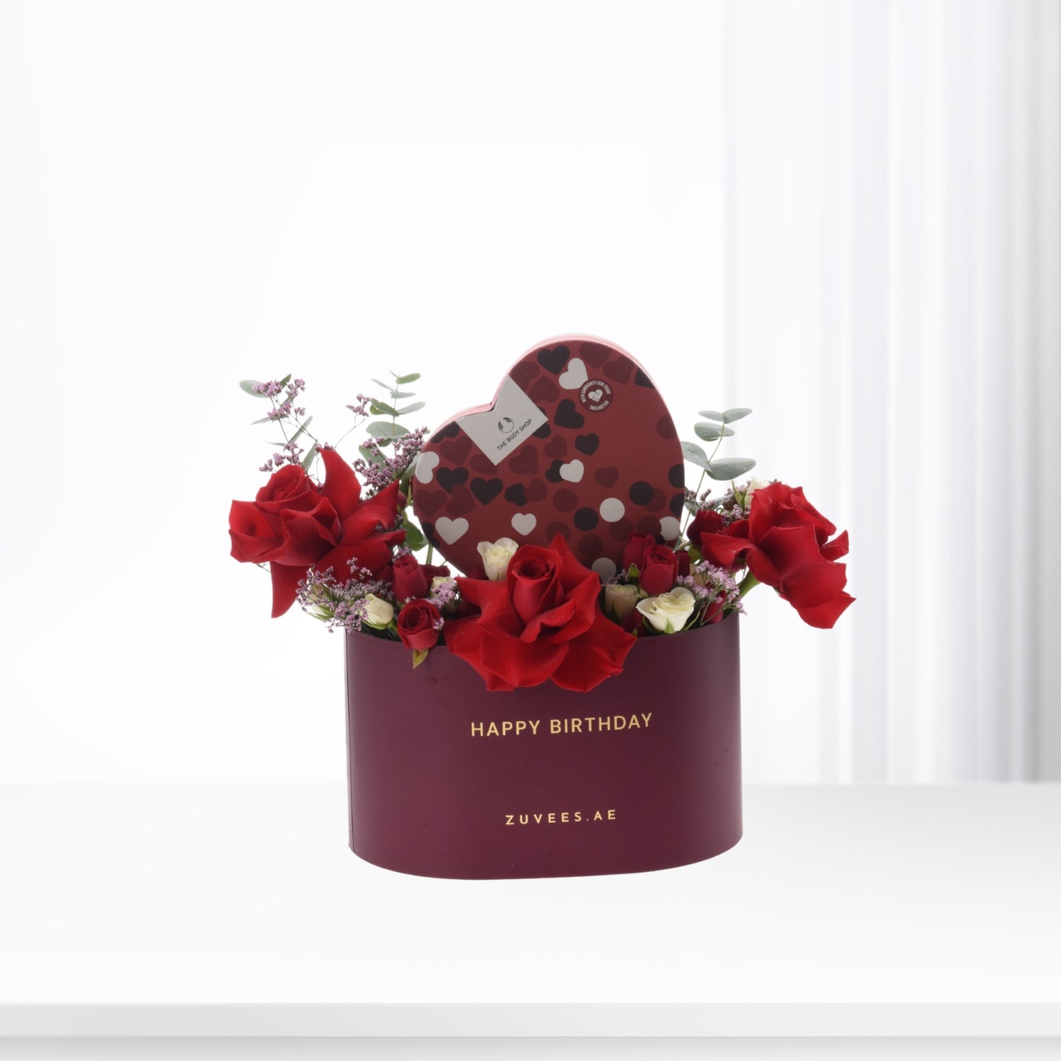 Rich burgundy box with red roses, heart chocolate, and "Happy Birthday" text.