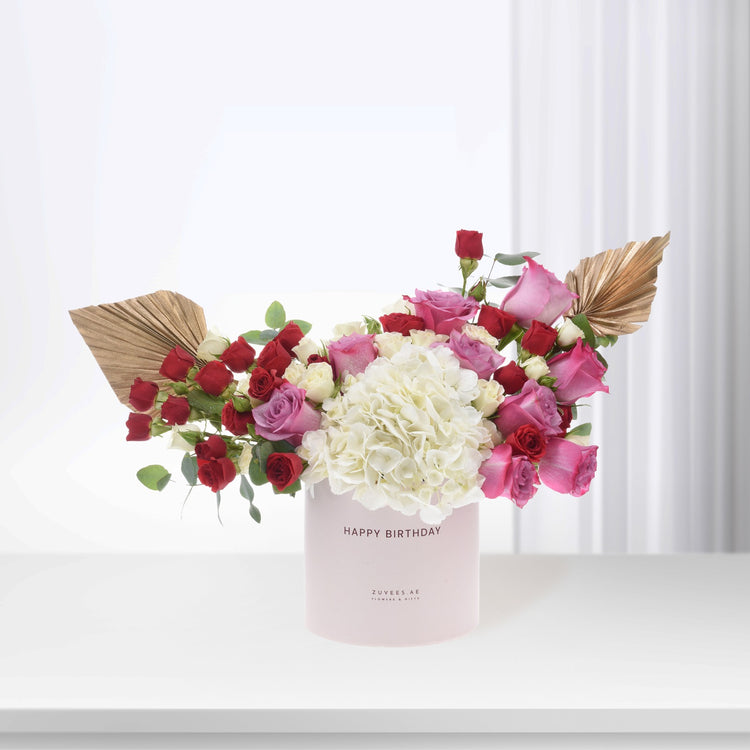 Pink vase with red, pink, and white roses and hydrangeas, gold leaf accents, "Happy Birthday" text.