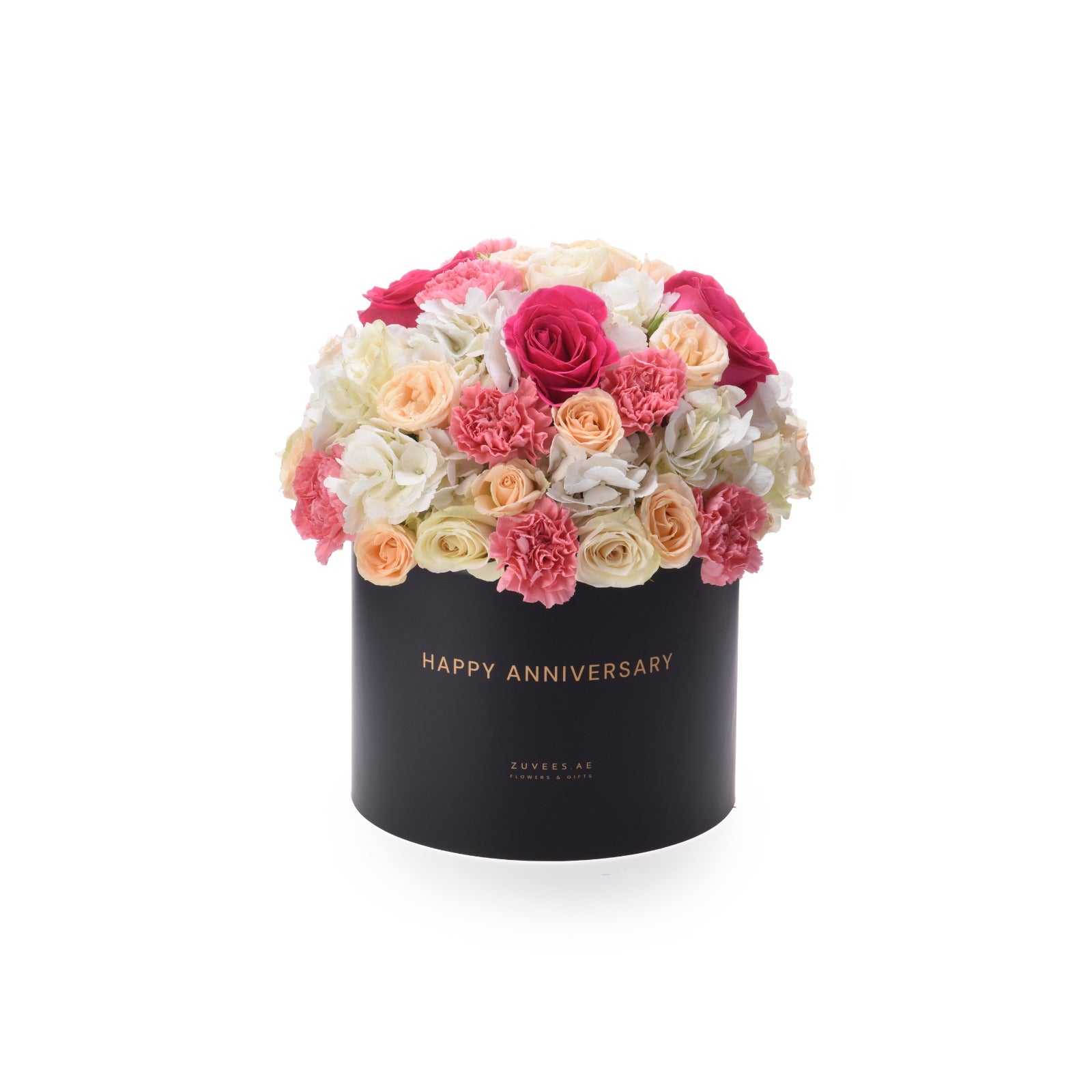 Black box with "Happy Anniversary" in gold, overflowing with pink, peach, and white roses and carnations.