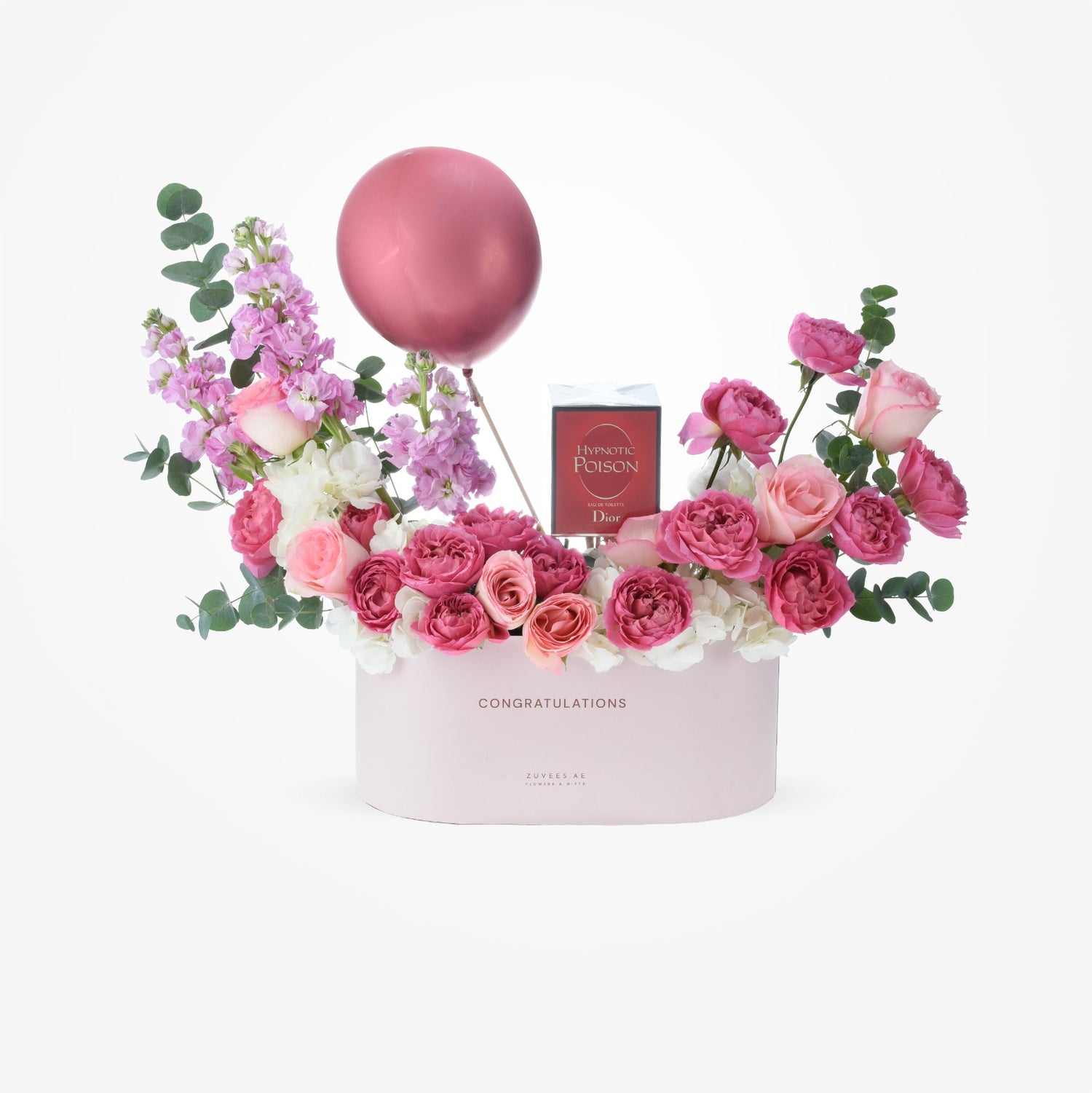 Pink floral arrangement with balloon and perfume in "Congratulations" box.