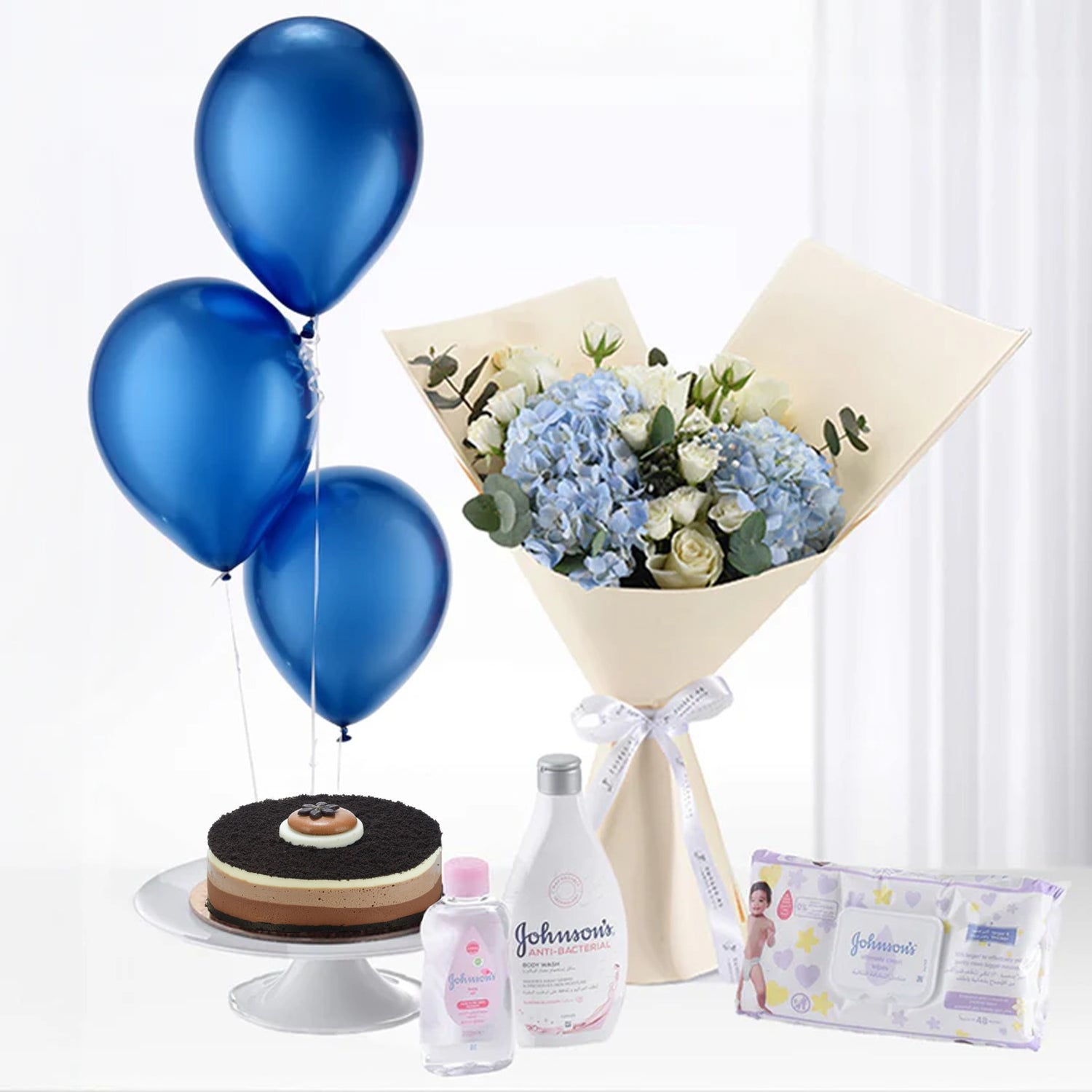 Blue balloons, hydrangea bouquet, cake, and Johnson’s baby care products.