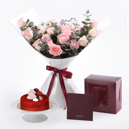 Pink rose bouquet with red ribbon, red velvet cake, and branded gift boxes.