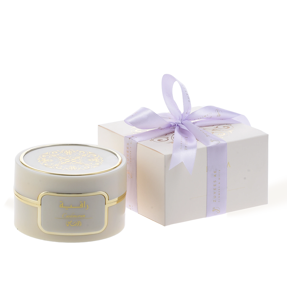 Elegant cream candle with gold Arabic script, paired with lavender ribbon gift box.