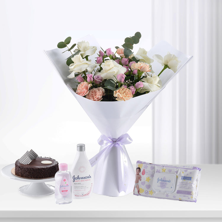 Elegant white bouquet with pink roses, chocolate cake, Johnson’s baby products, soft purple ribbon.