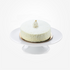 White coconut cake topped with gold leaf, elegantly displayed on a white cake stand.