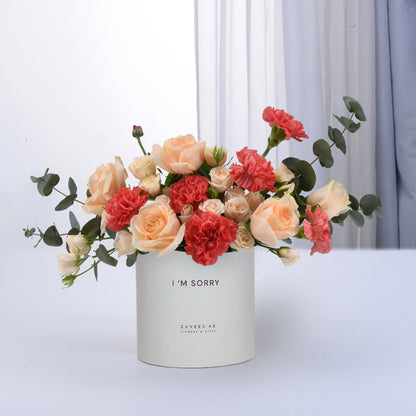 Peach roses, coral carnations, eucalyptus in white "I&
