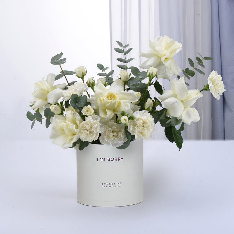 White roses and carnations in minimalist vase with “I&