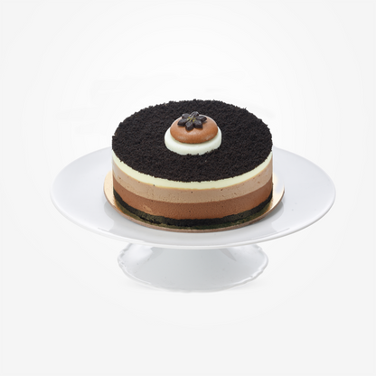 Layered chocolate cake with cookie crust, topped with delicate chocolate flower.