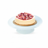 Creamy cheesecake topped with sliced strawberries and rose petals on light blue cake stand.
