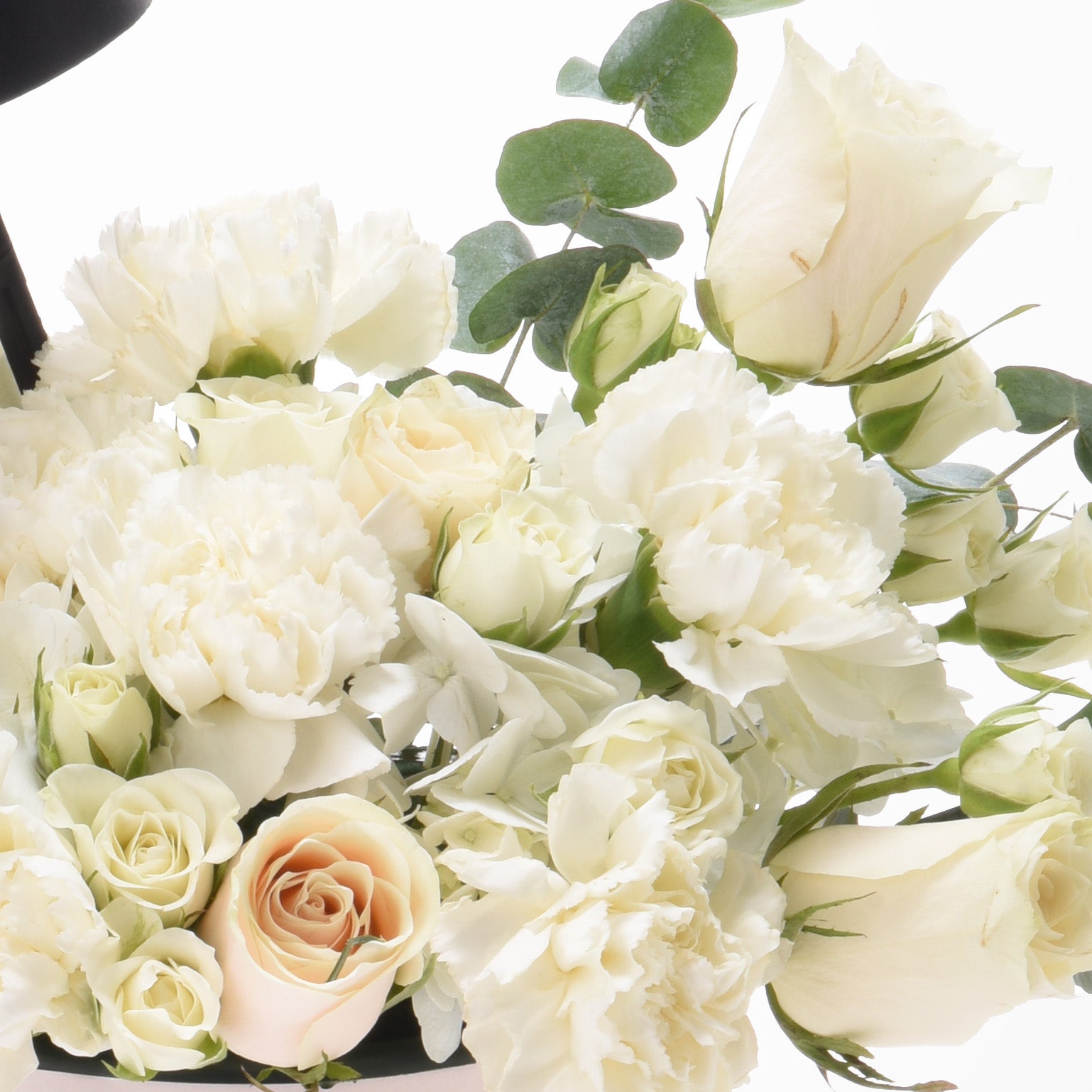 Elegant white roses, carnations, and eucalyptus in soft, romantic floral arrangement.
