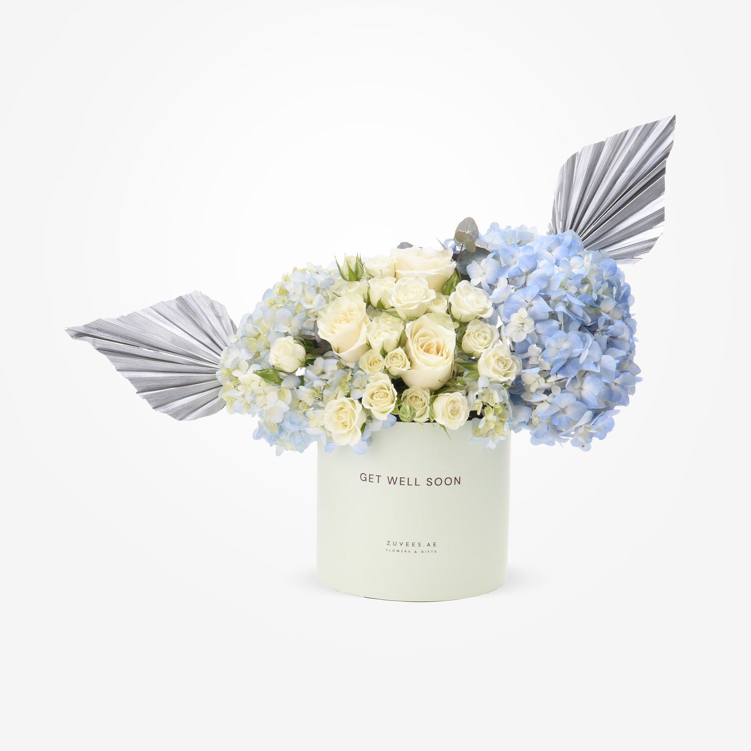 Elegant white roses, blue hydrangeas, silver foliage in mint "Get Well Soon" gift box.