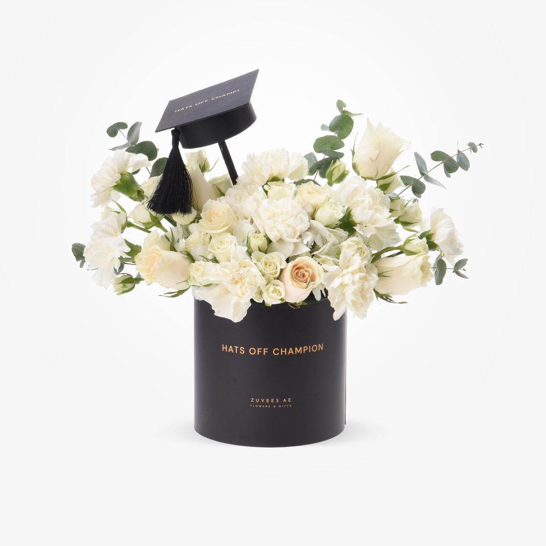 Elegant white roses and eucalyptus in black graduation cap-themed cylinder.