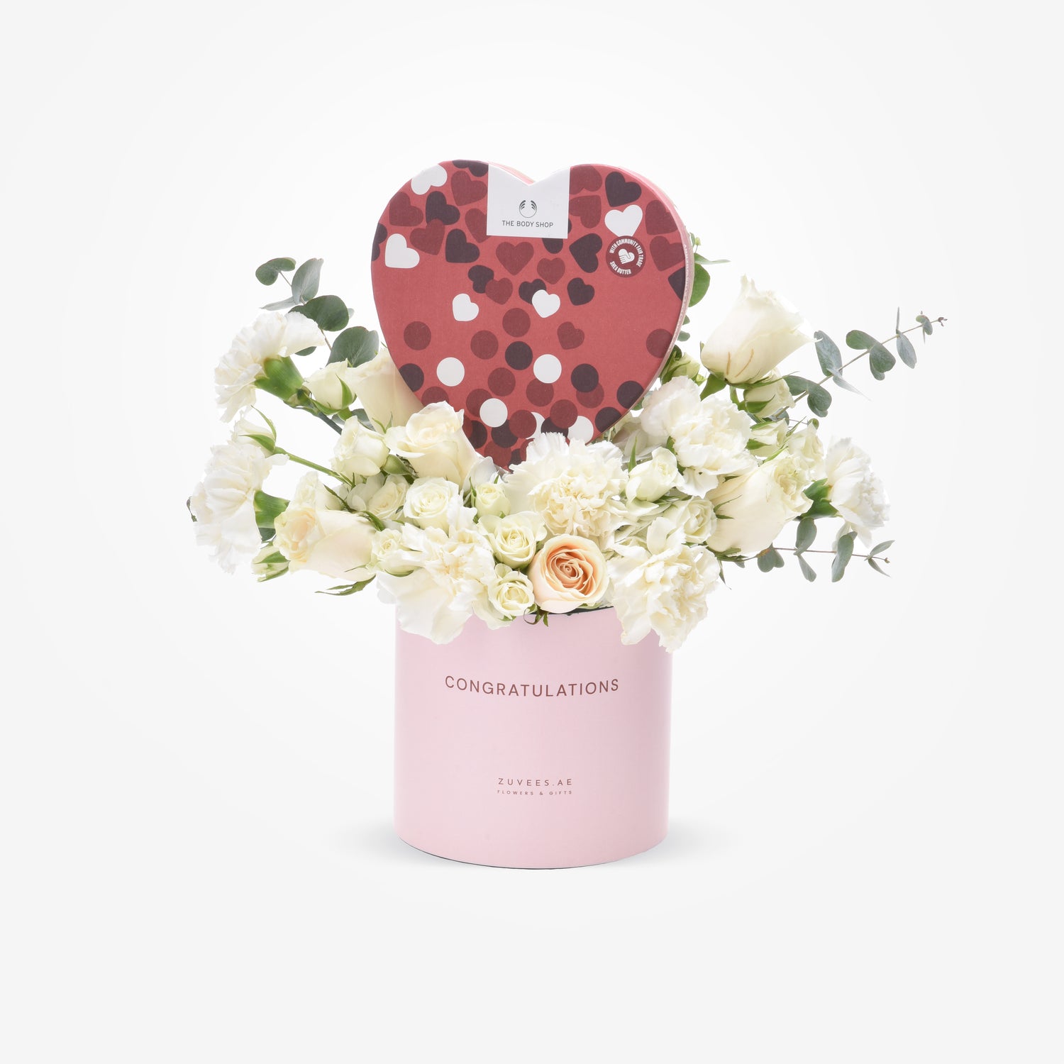 Pink "Congratulations" cylinder holds white roses, carnations, and a heart-shaped The Body Shop chocolate box.