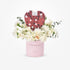 Pink "Congratulations" cylinder holds white roses, carnations, and a heart-shaped The Body Shop chocolate box.