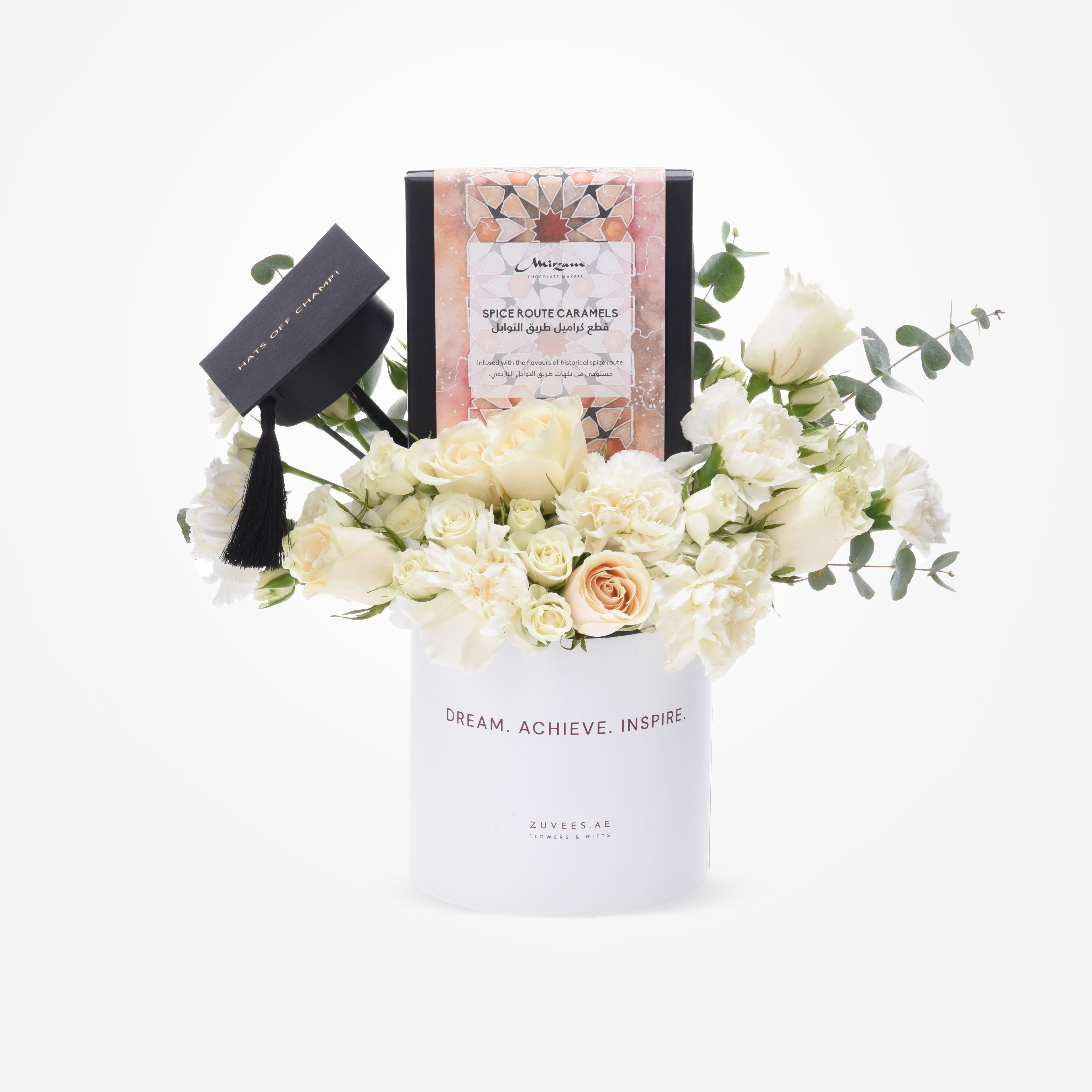 Elegant white floral arrangement with graduation cap and spice caramel gift box.