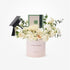 Elegant white roses and eucalyptus in blush box with graduation cap and Patchi gift.
