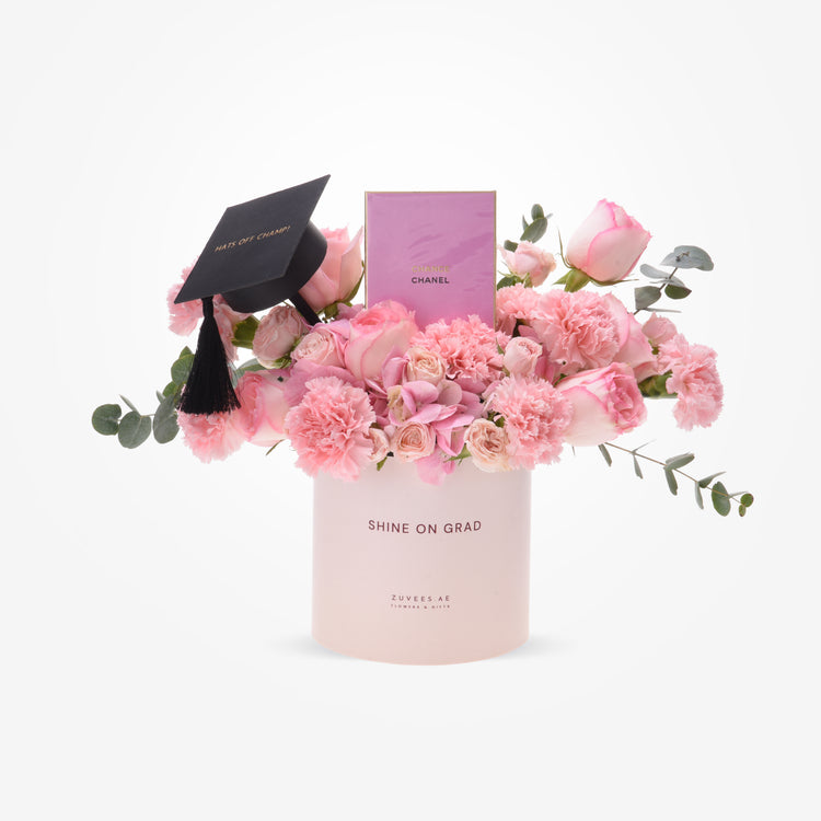 Pink roses and carnations in a "Shine On Grad" box with graduation cap and Chanel perfume.