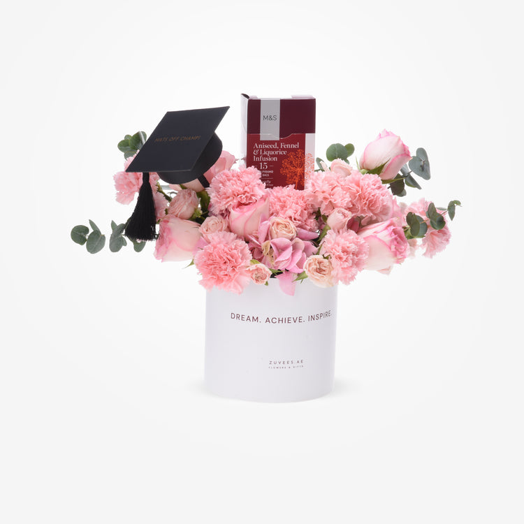Pink floral graduation gift with black cap and tea box.