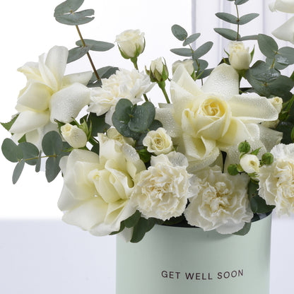 White roses and carnations with dewdrops in mint "Get Well Soon" vase.