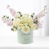 Pastel mint box holds creamy roses, lavender blooms, and eucalyptus—“Get Well Soon” message.