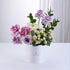Elegant lavender, pink, and cream roses in white cylindrical box.