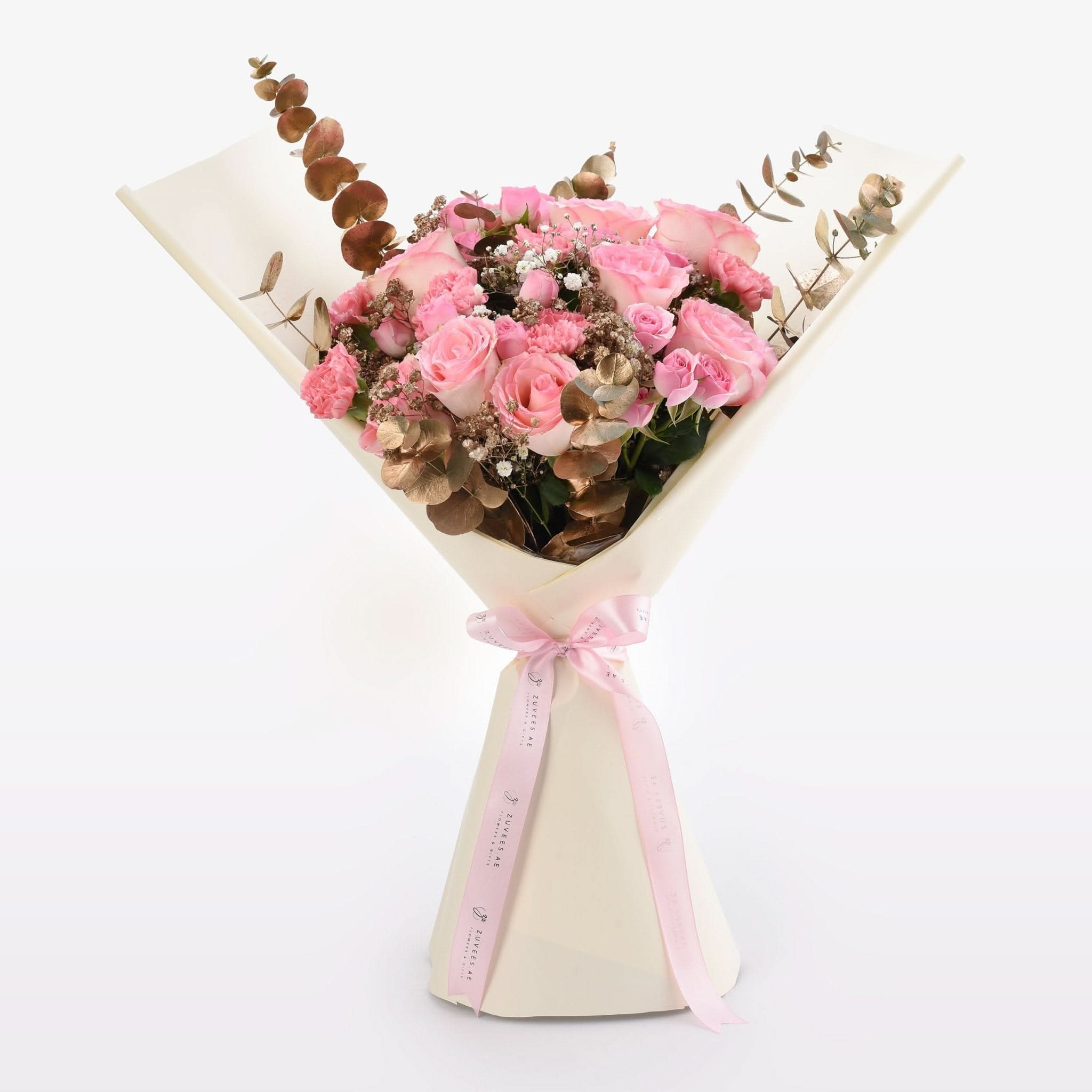 Soft pink roses, gold eucalyptus, and baby’s breath wrapped in cream paper with pink ribbon.