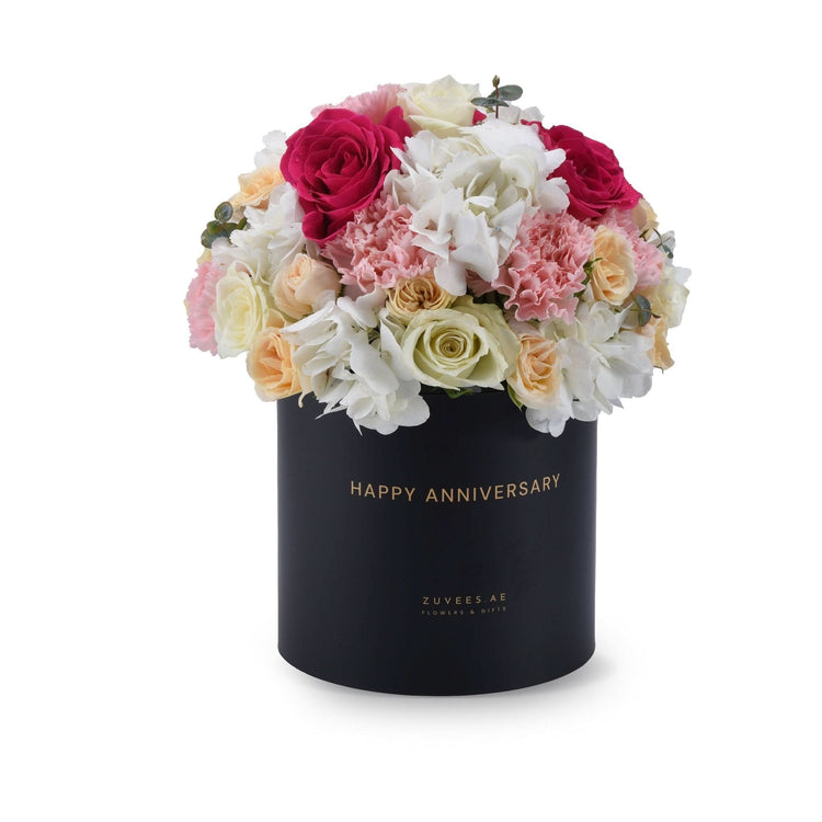 Elegant black box filled with vibrant pink, white, and cream roses and hydrangeas.