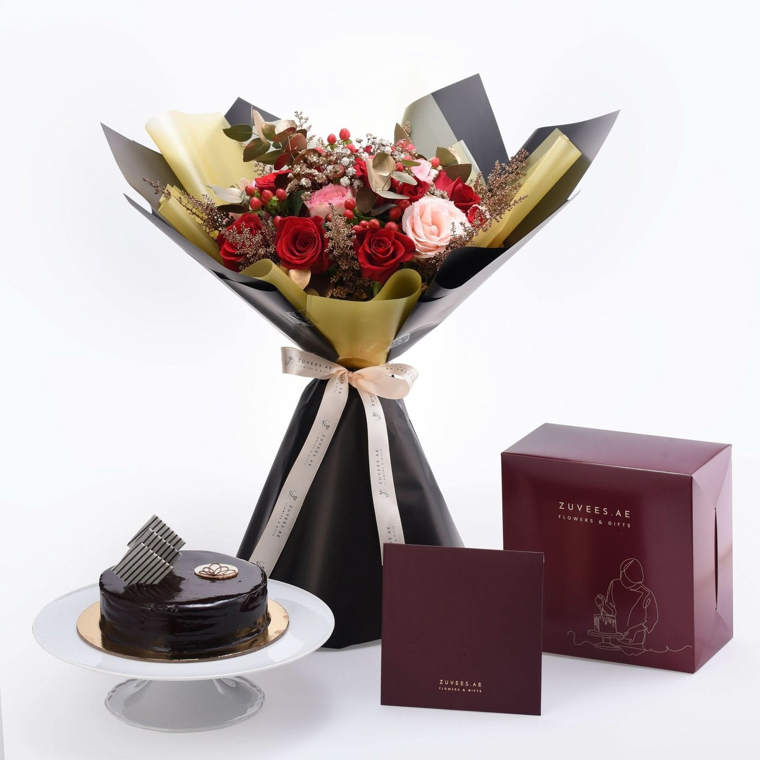 Luxurious red and pink rose bouquet with chocolate cake and branded gift box.