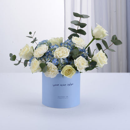 White roses, blue hydrangeas, eucalyptus in light blue Zuvees gift box, elegant minimalist design.