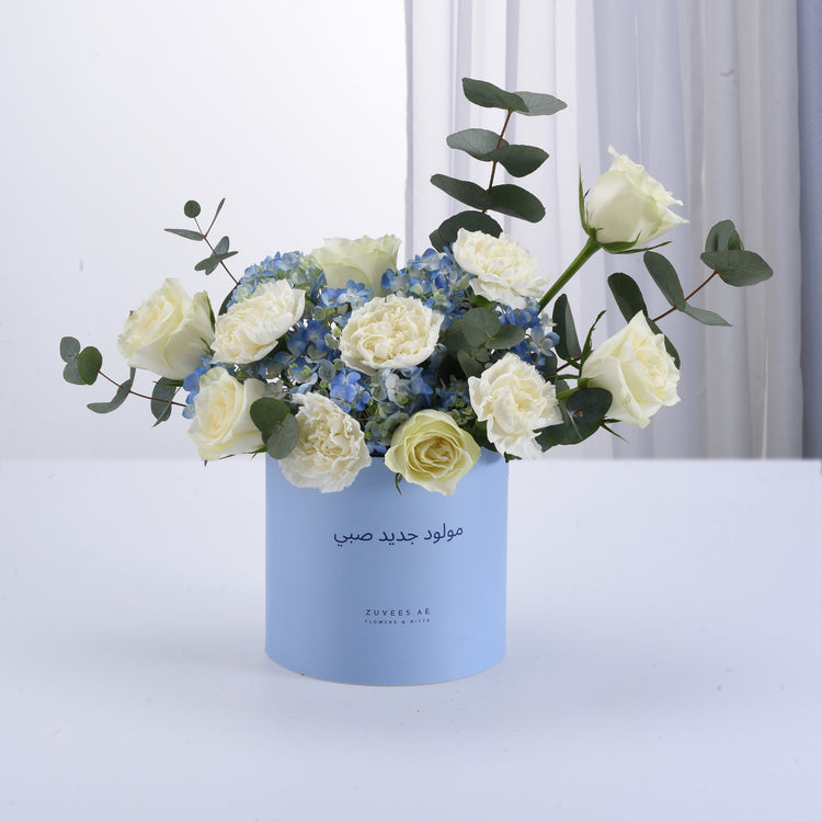 White roses, blue hydrangeas, eucalyptus in light blue Zuvees gift box, elegant minimalist design.