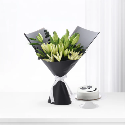 Elegant white lilies in black wrap with ribbon, beside minimalist white cake on stand.