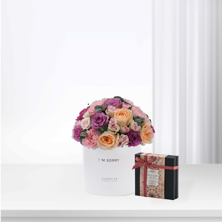 White box holds vibrant pink, purple, peach roses with "I&
