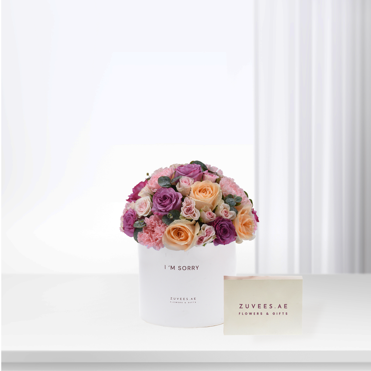 White box holds vibrant pink, purple, peach roses with “I&