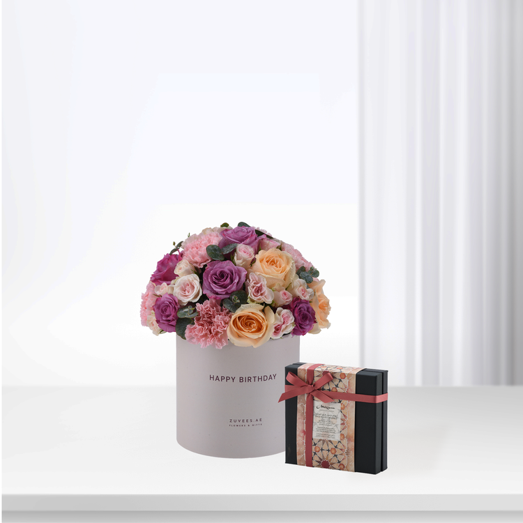Pastel pink, purple, and peach roses in white box with "Happy Birthday" text.