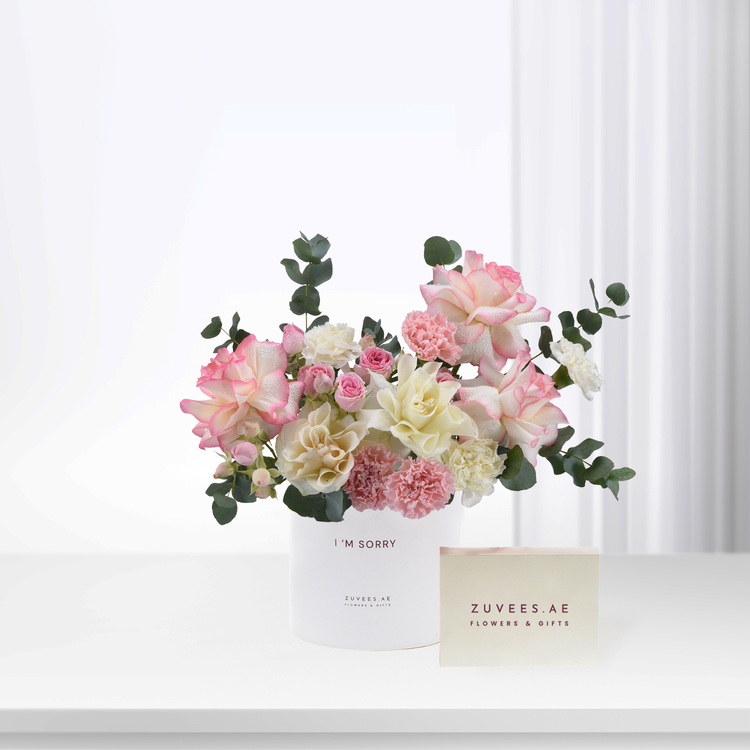 Soft pink and white roses, carnations, eucalyptus in minimalist white vase with "I&